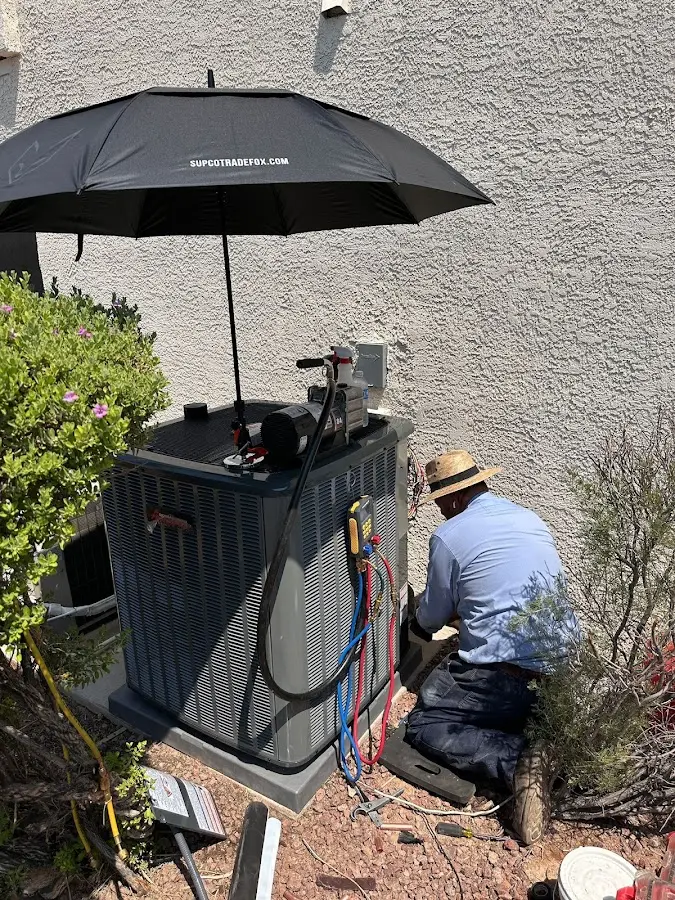 HVAC technician performing outdoor AC maintenance in Creston